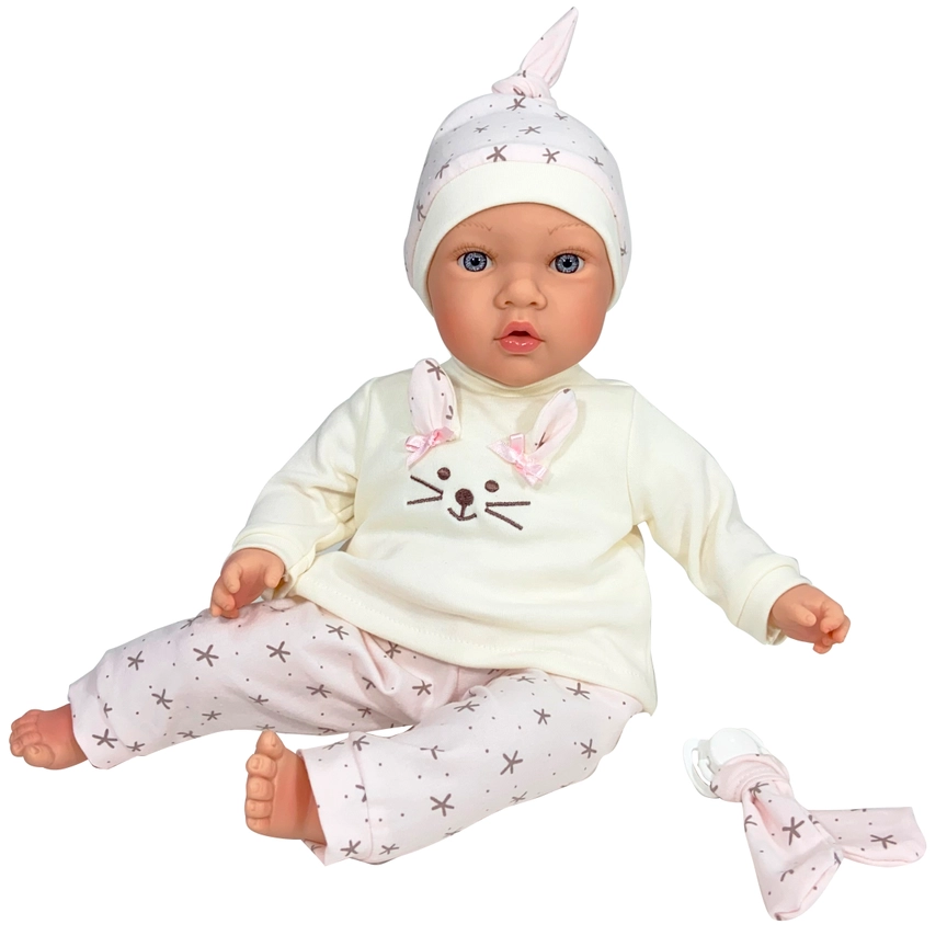 Realistic baby doll in pink star-patterned outfit with matching hat, seated with a pacifier and holder nearby.